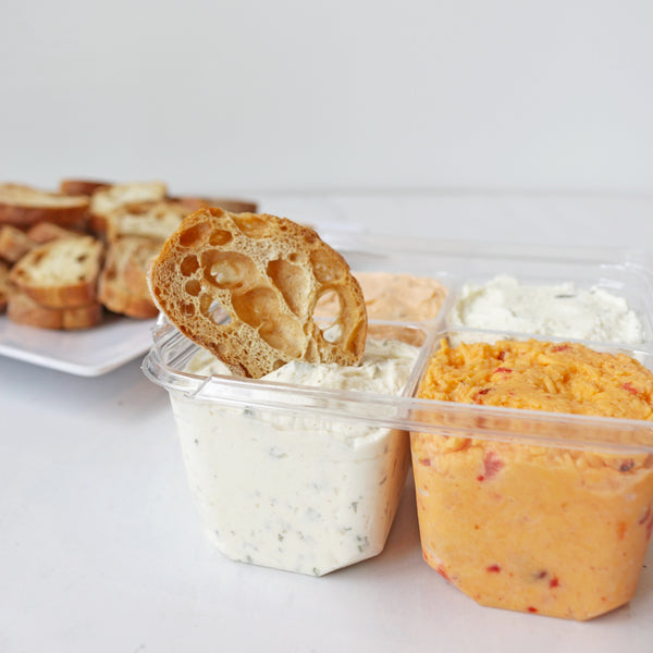 A plate of TASTE BAkehouse crostini crackers with assorted cheese