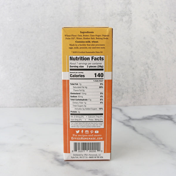 the side of a  packaged product labeled 'Effie's Homemade Oatcake Biscuit Crackers' showing nutrition facts and ingredients, displayed on a marble surface.