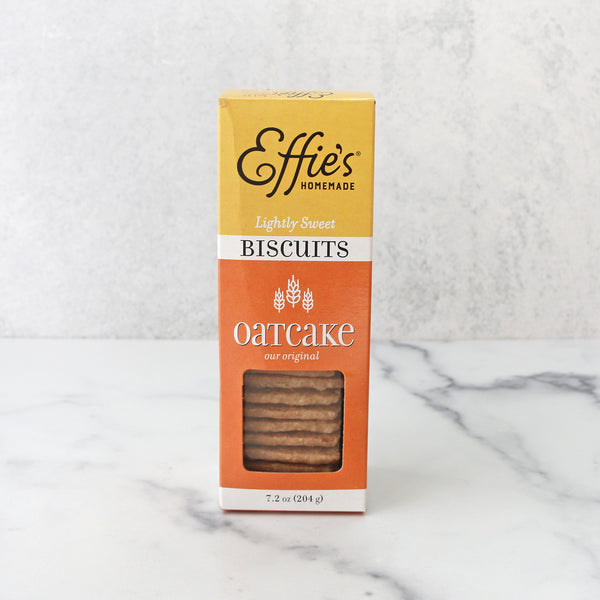 A packaged product labeled 'Effie's Homemade Oatcake Biscuit Crackers' displayed on a marble surface.