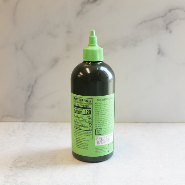 A bottle of Graza 'Drizzle' Extra Virgin Olive Oil with a green cap, labeled for culinary use. Shows Nutrition Facts.