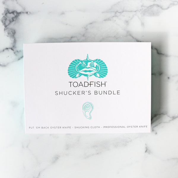 The image shows a set of oyster shucking tools within a box 